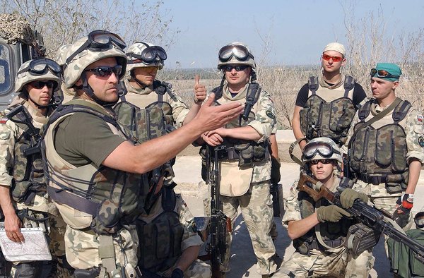 The Polish patrol is debriefed by the team leader after completing the afternoon patrol around the perimeter of Camp Babylon, Iraq, during Operation IRAQI FREEDOM. Two of the Soldiers show their 7.62 mm PKM light machine guns and all are wearing body armor.<br /><br />Date<br />    21 Mar 2004<br />Location<br />    Perimeter of Camp Babylon, Iraq<br />Camera Operator<br />    SSGT RICKY A. BLOOM, USAF<br />Photo ID<br />    DFSD0416537<br />    040321F2902B017